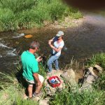 Amigos Bravos volunteers sampling water in the Rio Fernando